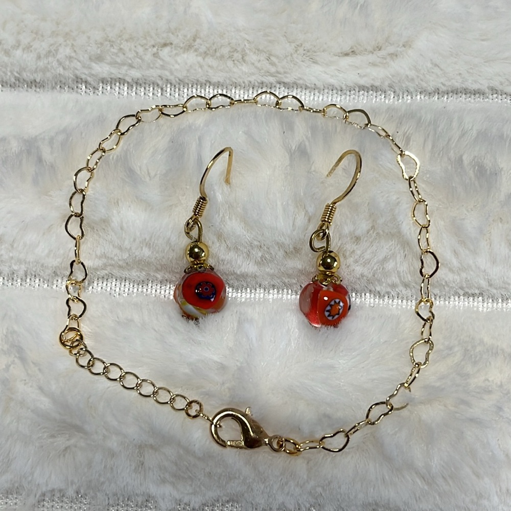 Beautiful gold tone heart design bracelet and  French wire earring set.